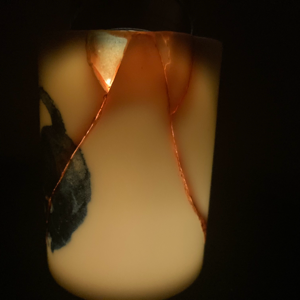 backlit teacup with visible mending